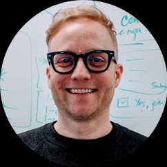 Russ Vance smiling in front of a whiteboard